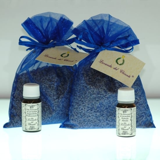 Two blue organza bags with cream label with Lavanda del Chianti writing and Casalvento symbol with laurel wreath and brass cap, 2 yellow pharmaceutical bottles with white cap with Casalvento essential oils
