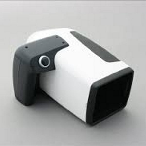 Special white imaging camera with black handle on light neutral background for imaging skin