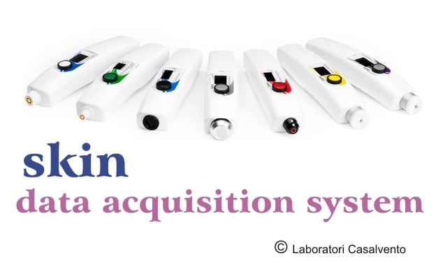 You can see 7 Delfin electronic instruments in white with gray, yellow, red, black, green, blue and white activation button with skin and Casalvento Laboratories written in blue on a white background