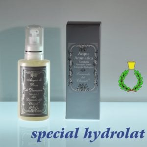 200ml plastic bottle with spray dispenser and silver box on a light blue background and reflections on a glass surface