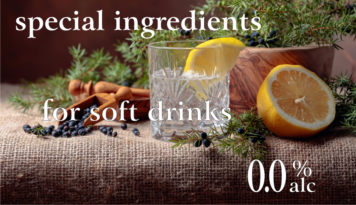 Clear glass tumbler with soft drink, cut lemon juniper sprigs and berries on burlap bale background. White lettering: special ingredients non-alcoholic liqueur 0% alcohol